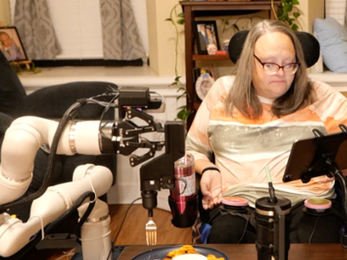 A care recipient using the FEAST mealtime-assistance robot at home